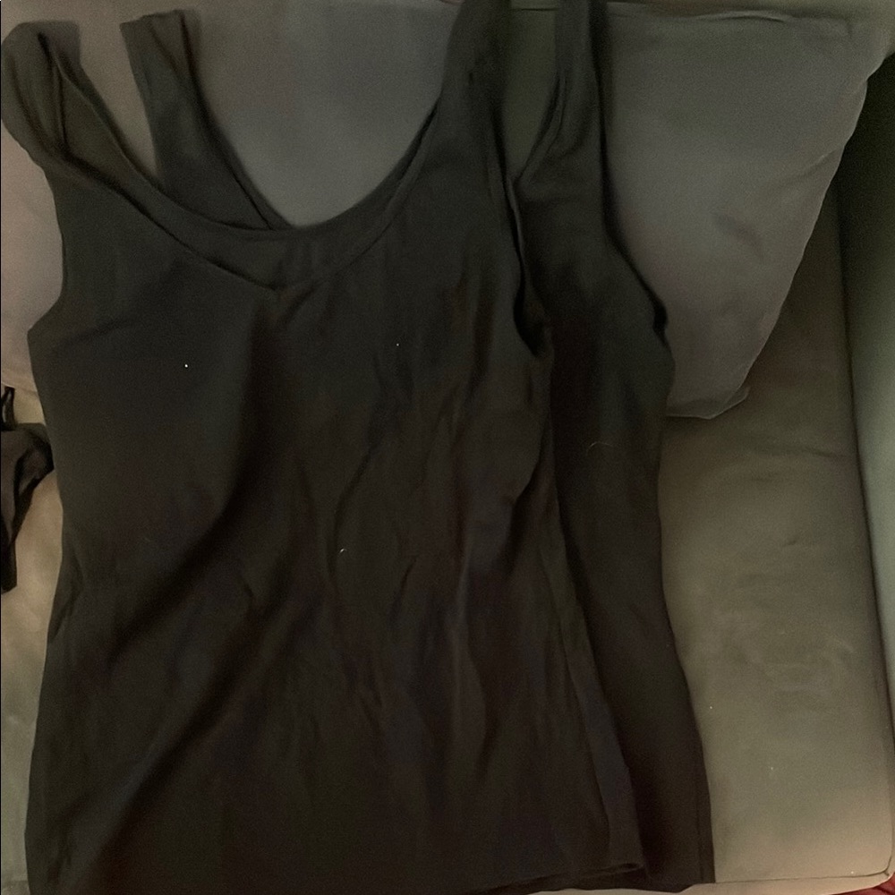 Source Unknown , Two Black Sleeveless Tank Tops
